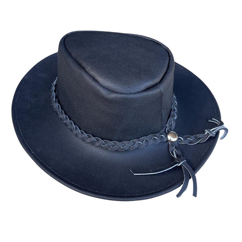 May include: A black leather hat with a wide brim and a cylindrical crown. A braided leather band with a silver-colored button and leather ties encircles the hat. The hat is designed for sun protection and style.