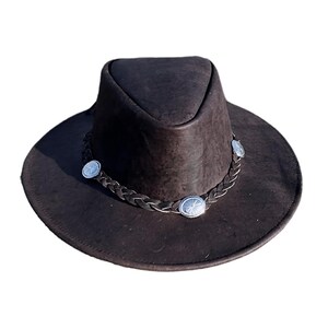 May include: A brown leather cowboy hat with a braided band and silver conchos.