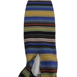 May include: A striped surfboard cover with a blue, yellow, black, and red color scheme. The cover has a drawstring closure and is made of a woven fabric.