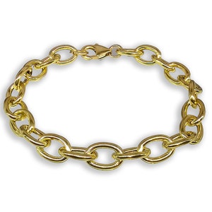 May include: A gold chain bracelet with oval links.