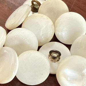 May include: A set of three ceramic mugs with a speckled, matte finish. Each mug features a different color: light blue, cream, and gray. The mugs have a simple, modern design and a comfortable handle.