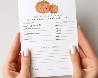 May include: A white card with the text "OUR LITTLE PUMPKIN prediction and advice" and pumpkin illustrations. The card includes sections for birth predictions and advice to parents. The card is held by a person.