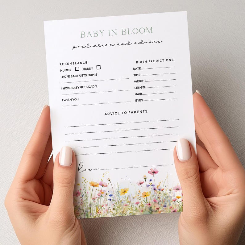 May include: A white card with the text "BABY IN BLOOM prediction and advice" and floral illustrations. The card includes sections for resemblance, birth predictions, and advice to parents. The bottom of the card has the word "love" in cursive.