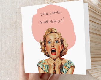 May include: A white greeting card with the text "O.M.G. SARAH You'RE HOW OLD!" above a vintage illustration of a surprised woman with wide eyes and open mouth. The woman is wearing a blue and green patterned dress.