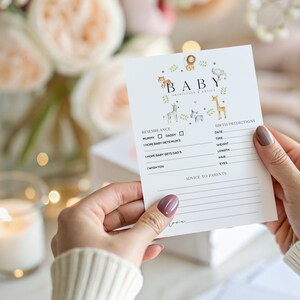 May include: A white baby prediction and advice card with the word "BABY" at the top, surrounded by animal illustrations. The card includes sections for resemblance, birth predictions, and advice to parents.