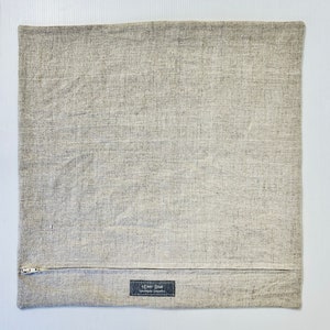 May include: A gray linen pillow cover with a zipper closure and a small label that reads "Ever Blue Handmade Originals".