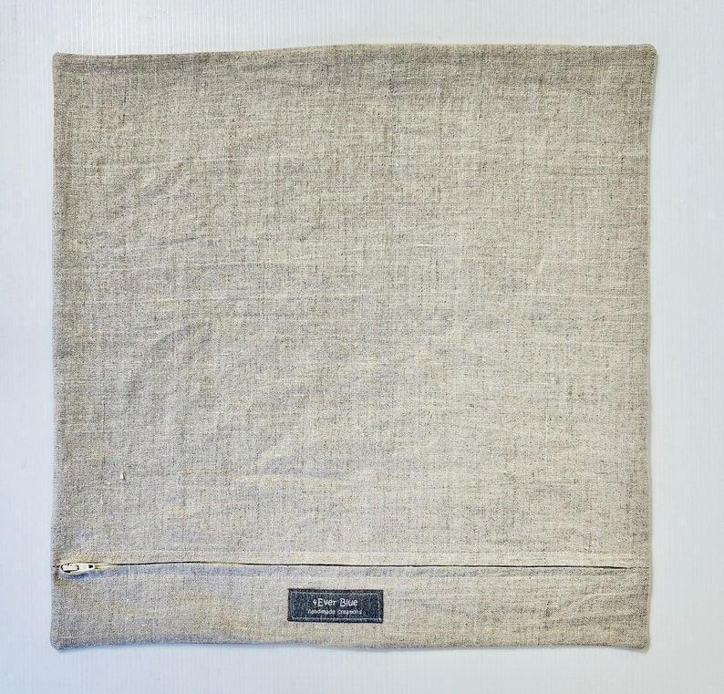 May include: A gray linen pillow cover with a zipper closure and a small label that reads "Ever Blue Handmade Originals".