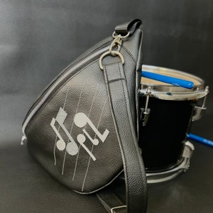 Large sling bag in Italian leather with stove and music notes decoration
