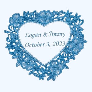 May include: A blue floral heart-shaped design with the names "Logan & Jimmy" and the date "October 3, 2023" embroidered in the center. The design features intricate floral and leaf patterns.