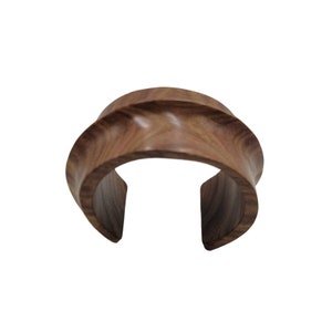 a wooden ring with a curved design on it