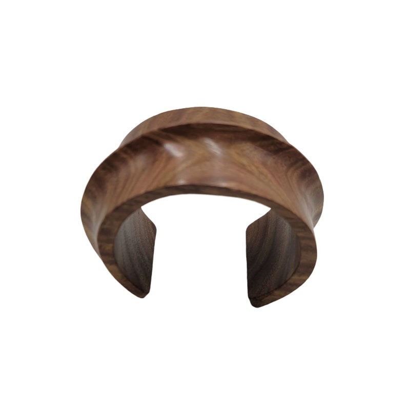 a wooden ring with a curved design on it