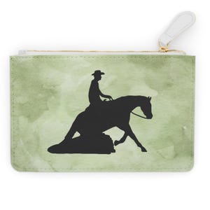 May include: A green and white zippered pouch with a silhouette of a rider on a horse. The rider is wearing a hat and the horse is in a reining pose.