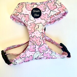 May include: Pink dog harness with a cookie pattern and a black patch that says "Smash Face".