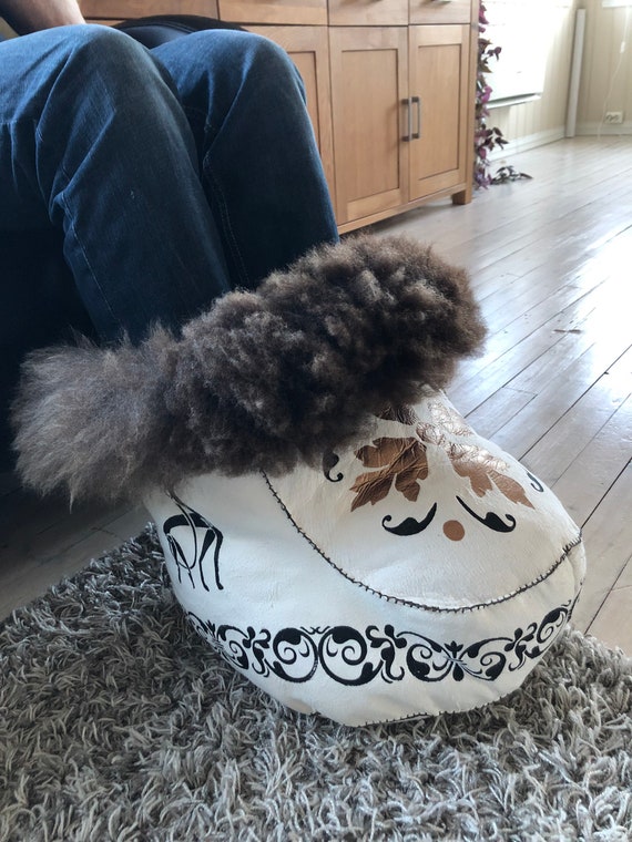Exclusive foot warmer hand sewn from sheepskin with hand painted and hand printed decorations. Norwegian make.