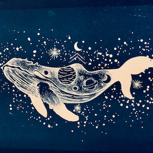 May include: A white whale silhouette with a galaxy inside, set against a dark blue background with white dots representing stars.