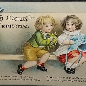 Christmas Postcard Children on Bench Boy Offering Mistletoe Artist Ellen Clapsaddle IAP Publishing