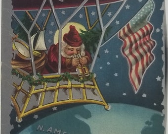 Christmas Postcard Santa Claus in Airship Zeppelin Over USA with Binoculars Holding American Flag Silver Trim