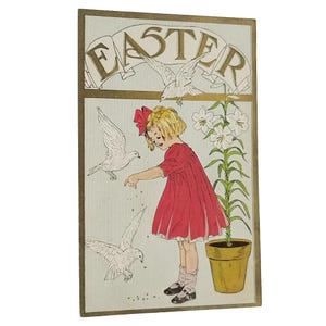 May include: Vintage Easter-themed illustration featuring a young girl in a red dress with a bow, feeding doves. The word "EASTER" is displayed above the girl in gold lettering. White lilies are in a yellow pot.