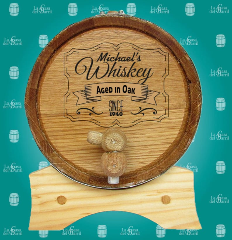 May include: A wooden barrel with a metal band and a wooden tap. The barrel is decorated with a personalised label that reads "Michael's Whiskey Aged in Oak Since 1940".