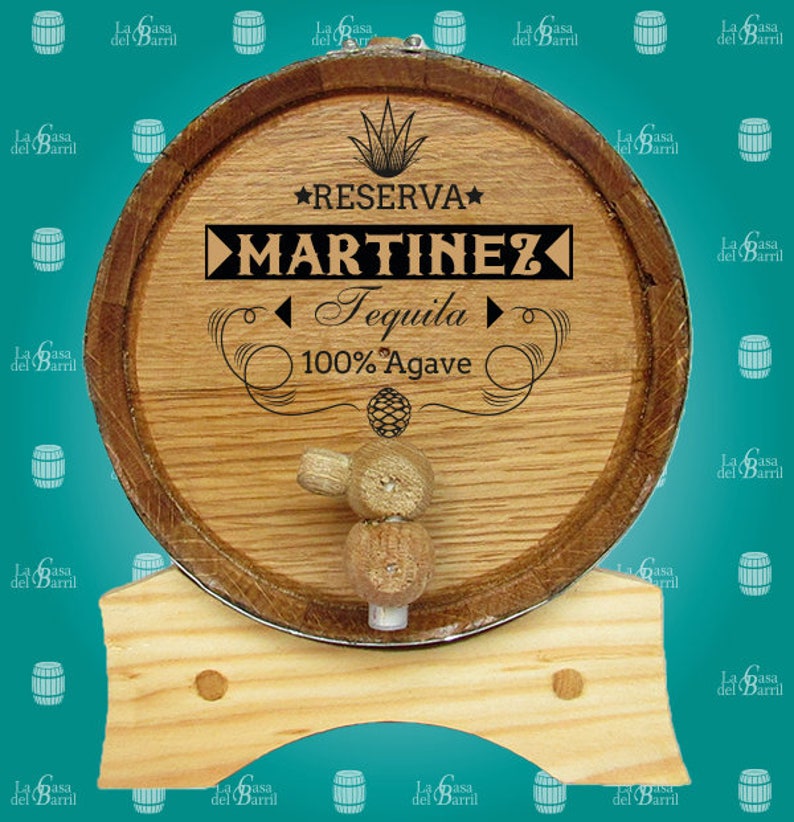 May include: A wooden barrel with a metal band and a wooden tap. The barrel is labelled "RESERVA MARTINEZ Tequila 100% Agave".