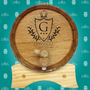 May include: A wooden barrel with a metal band and a wooden stand. The barrel is decorated with a shield featuring a letter G and a crown. The text "GONZ&Aacute;LEZ - RESERVA ESPECIAL -" is printed on the barrel.