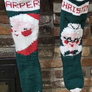 May include: Two knitted Christmas stockings with Santa and Mrs. Claus faces. The stocking on the left is green with white trim and says "Harper" at the top. The stocking on the right is green with white trim and says "Christine" at the top.