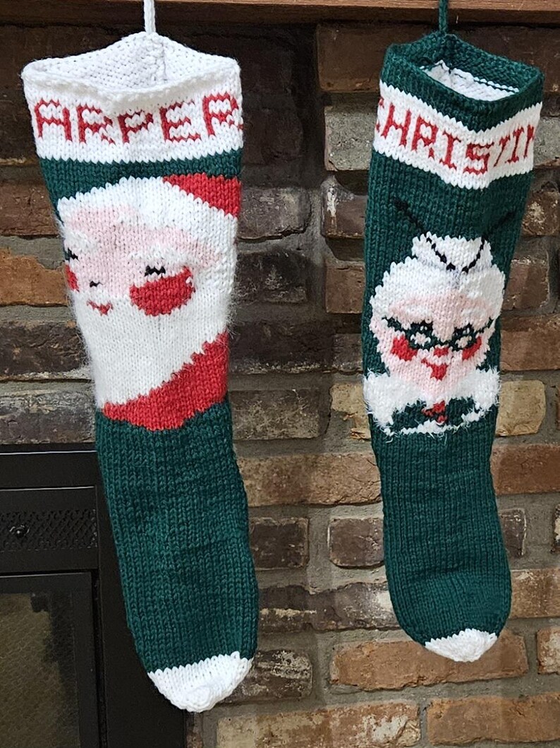 May include: Two knitted Christmas stockings with Santa and Mrs. Claus faces. The stocking on the left is green with white trim and says "Harper" at the top. The stocking on the right is green with white trim and says "Christine" at the top.