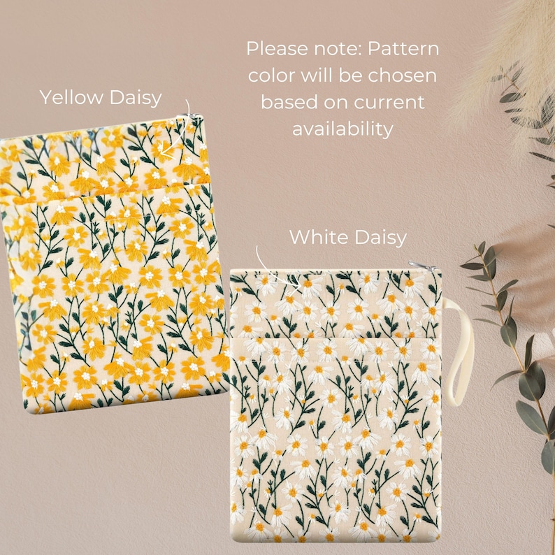 May include: Two floral patterned pouches are shown, one with yellow daisies and the other with white daisies. The text "Yellow Daisy" and "White Daisy" are above each pouch. The text "Please note: Pattern colour will be chosen based on current availability" is also present.