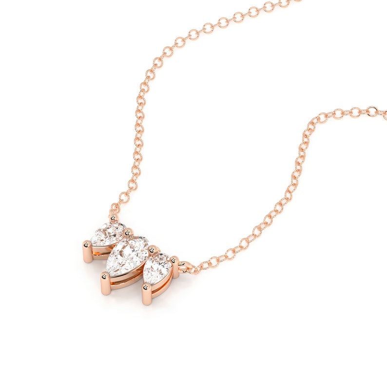 This is a dainty and elegant 14K solid gold lab diamond necklace, set with sparkling pear cut diamonds in an elegant pendant, the perfect diamond anniversary necklace.