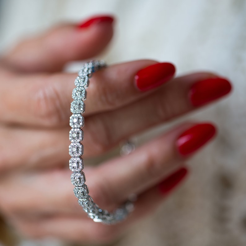 This unique diamond tennis bracelet features stunning pave set diamond clusters on cushion shape links that sparkle and shine with every movement.