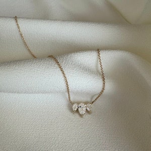 This is a dainty and elegant 14K solid gold lab diamond necklace, set with sparkling pear cut diamonds in an elegant pendant, the perfect diamond anniversary necklace.