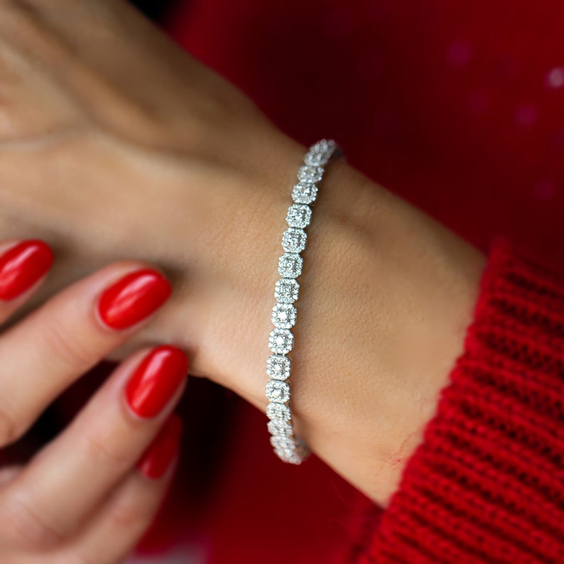 This unique diamond tennis bracelet features stunning pave set diamond clusters on cushion shape links that sparkle and shine with every movement.