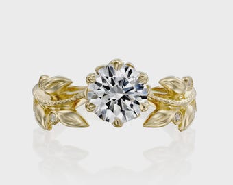 May include: A gold ring featuring a large, round, clear faceted center stone held by prongs. The band is designed with sculpted gold leaves and small, round, clear accent stones embedded within the leaf-shaped metalwork on both sides.
