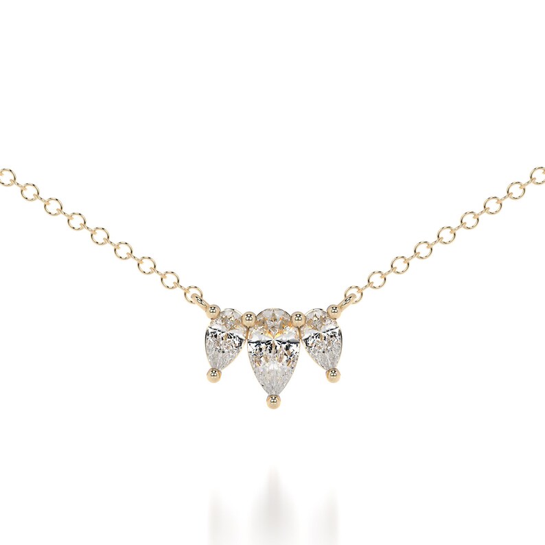This is a dainty and elegant 14K solid gold lab diamond necklace, set with sparkling pear cut diamonds in an elegant pendant, the perfect diamond anniversary necklace.