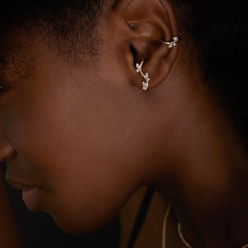 This gentle nature-inspired design showcases a 14K gold and diamonds branch climbing your ear.