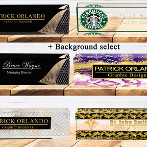 May include: A collection of ten different acrylic desk nameplates with various background designs. The nameplates feature different names and job titles, including "Patrick Orlando, Graphic Designer", "Bruce Wayne, Managing Director", and "Dr. John Smith, Medical Doctor".