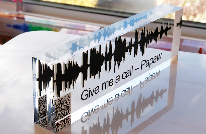 May include: A clear acrylic block with a black sound wave graphic and the text "Give me a call - Papaw".