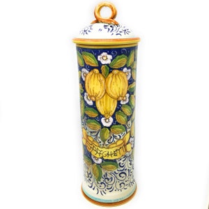 May include: A blue and white ceramic spaghetti jar with a yellow lemon design and the word "Spaghetti" written on it.