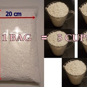 May include: A clear plastic bag filled with white polystyrene packing peanuts. The bag measures 20 inches wide and 28 inches tall. The text "1 BAG = 5 CUPS" is printed on the bag.