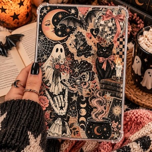 May include: A clear tablet case featuring a collage of gothic and celestial illustrations, including a crescent moon face, a ghost holding flowers, a black cat with a pink bow, a moth, a skeleton hand, a cauldron, and a disco ball with a bow.