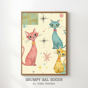 Pode incluir: Uma impressão emoldurada com quatro gatos estilizados em estilo retrô. Os gatos são rosa, azul e amarelo, com coleiras e gravatas borboleta decorativas. O fundo é creme com estrelas e detalhes geométricos. O texto "GRUMPY GAL GOODS ALL THINGS PRINTABLE" está na parte inferior.