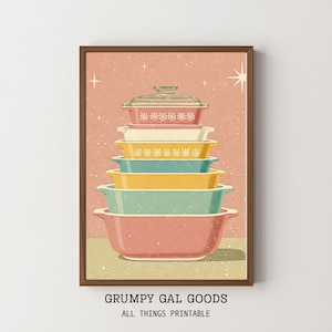 May include: A framed print depicting a stack of retro casserole dishes in pastel colours. The dishes are pink, yellow, blue, and white, with a glass lid. The print has a vintage feel, a textured background, and the text "GRUMPY GAL GOODS ALL THINGS PRINTABLE".