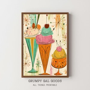 May include: A framed wall art print featuring three stylized ice cream sundaes in tall glasses with mid-century modern starburst patterns in the background. The illustration uses a palette of teal, pink, orange, and yellow with cherry toppings.
