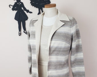 May include: A striped cardigan with a white collar and a matching dress. The cardigan is made of a soft, textured fabric and has a relaxed fit. The dress is a simple, knee-length style with a tie belt.