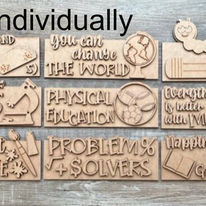 May include: Set of ten wooden signs with various school-themed phrases and illustrations. The signs feature phrases like "T is for Teacher", "Science Squad", "Let's get Creative", and "Problem Solvers".