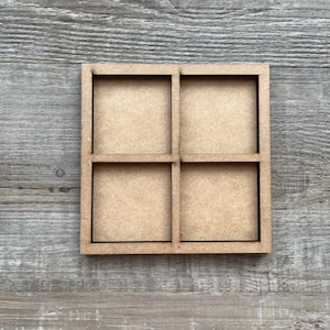 May include: A wooden tray with four square compartments. The tray is made of unfinished wood and has a natural brown color.