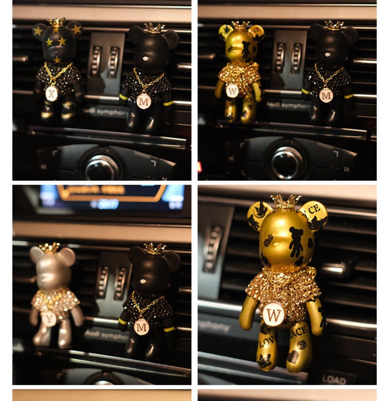 May include: Four car air fresheners shaped like bears wearing crowns and jeweled necklaces. The bears are black, silver, and gold. The gold bear has the letters "W", "ACE", and "LOV" on it. The black bears have the letter "M" on them. The silver bear has the letter "Y" on it.