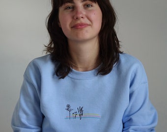 Embroidered floral colour block on a unisex sweater