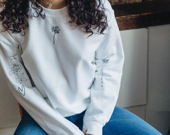 Embroidered tattoo style sweater with sleeve details