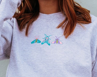 Embroidered trio of colourful moths sweater